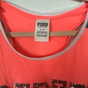 Pink tank top fits more like a large. Says medium on tag